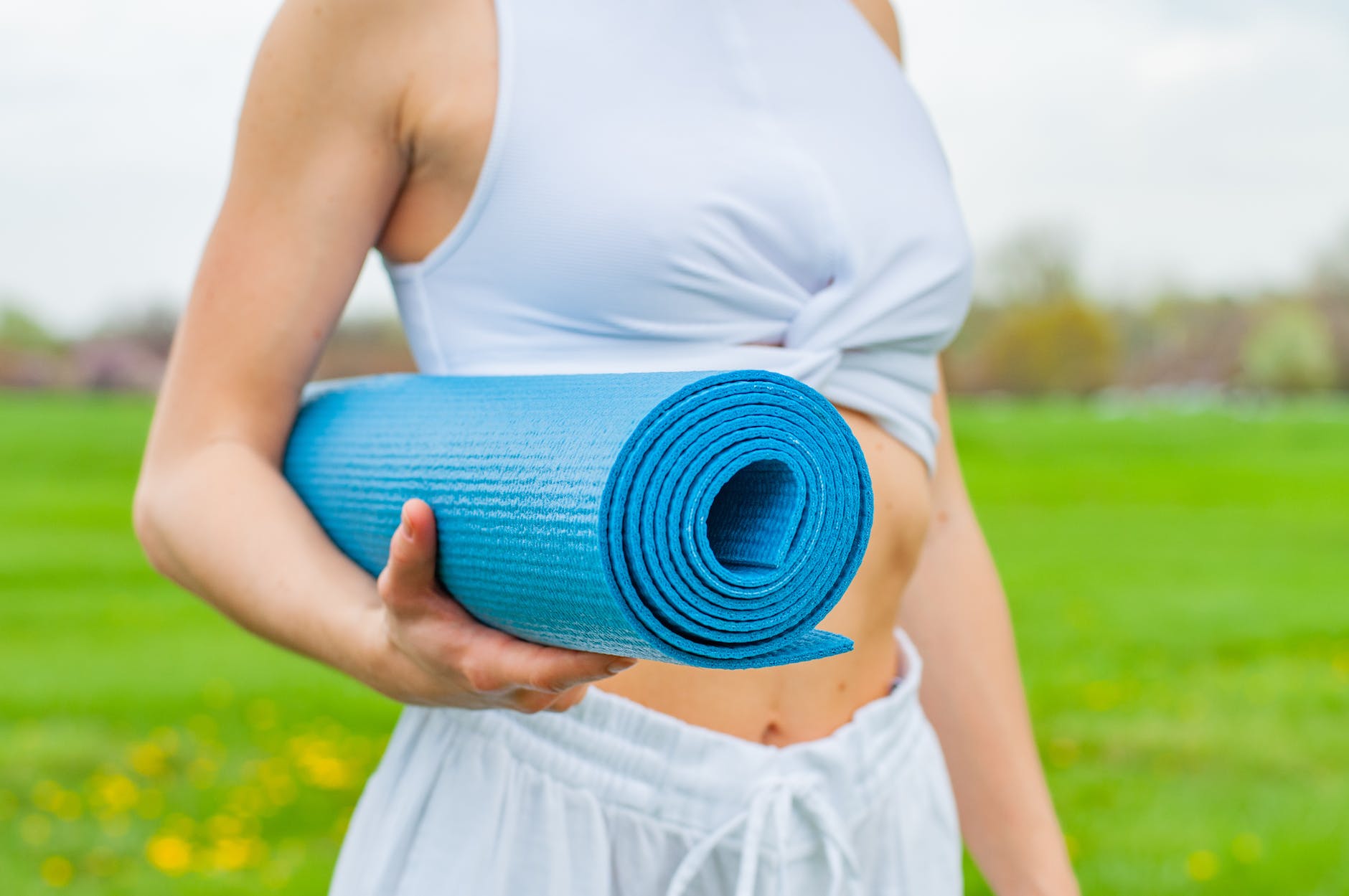 woman standing and holding blue yoga mat
Photo by Dmytro on Pexels.com